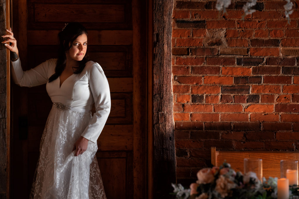 wedding picture of bride against exposed brick